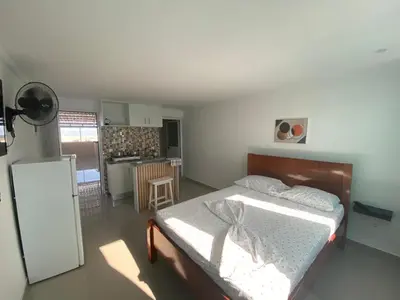 a small bedroom with a bed and a kitchen at My Flat 0 in Praia