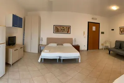 a bedroom with a bed and a tv and a couch at Salty Apartments in Santa Maria