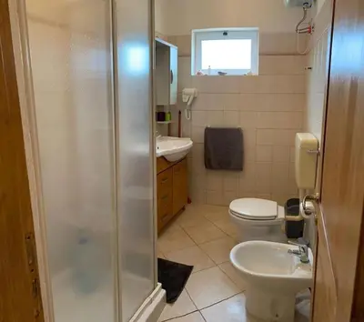 a bathroom with a shower and a toilet and a sink at Salty Apartments in Santa Maria