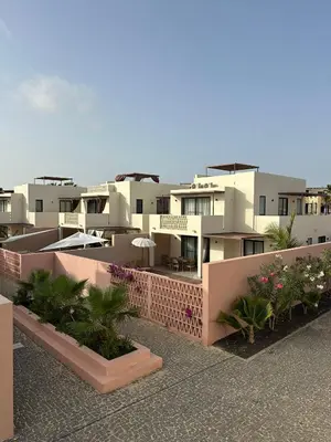 a view of a row of buildings with plants at Vila Cristina Alojamento, Praia Estoril, Boa Vista in Sal Rei