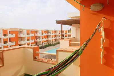 a hammock on the balcony of a apartment building at Nagoia's place com varanda, piscina e super wi-fi in Santa Maria