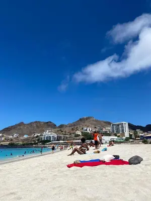 a group of people laying on a beach at Muralha Rooms in Mindelo