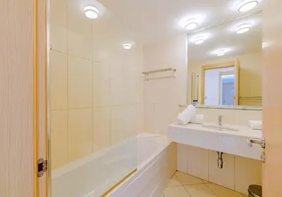 a white bathroom with a tub and a sink at Agua Hotels Sal Vila Verde in Santa Maria