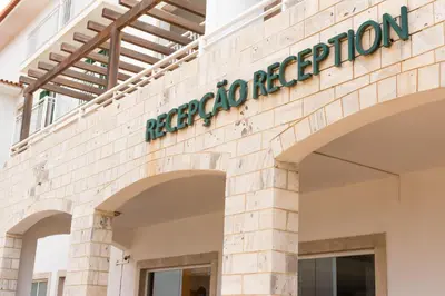a facade of a building with a sign on it at Agua Hotels Sal Vila Verde in Santa Maria