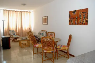 a living room with a table and chairs at Apartamentos Santiago - Praia in Praia