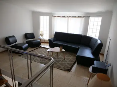a living room with a couch and a table at wonder of the archipelago in Praia