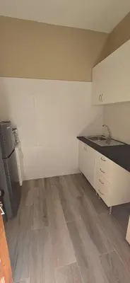 a kitchen with white cabinets and a counter top at City Center Mindelo 39 in Mindelo