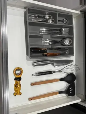 a drawer full of utensils in a refrigerator at Apartamento Batuku in Praia