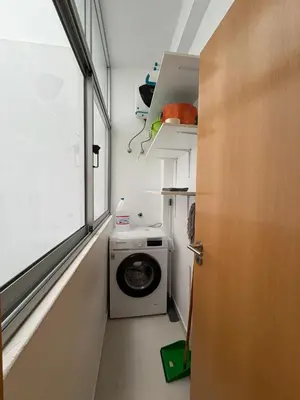 a laundry room with a washing machine and a window at Apartamento Batuku in Praia