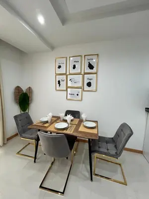 a dining room with a wooden table and chairs at Apartamento Ilhas in Praia