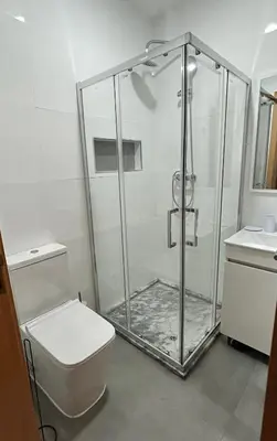 a bathroom with a shower with a toilet and a sink at Apartamento Ilhas in Praia
