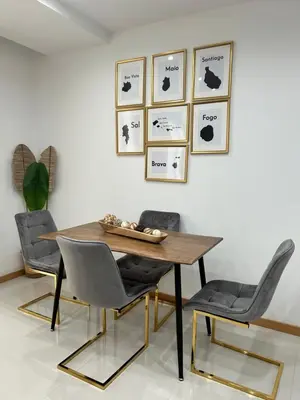 a dining room with a wooden table and four chairs at Apartamento Ilhas in Praia