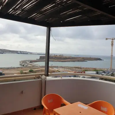 a view of the water from a restaurant with a table and chairs at Gamboa Praia in Praia