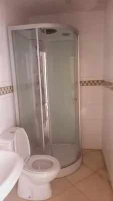 a bathroom with a shower and a toilet and a sink at Gamboa Praia in Praia