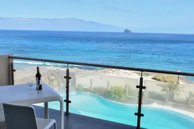 a balcony with a table and a view of the ocean at Duarte Apartments - Las Rochas in Mindelo