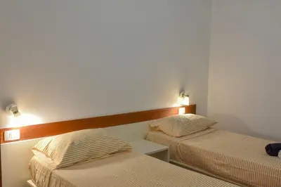 two beds in a small room with two beds at Duarte Apartments - Las Rochas in Mindelo