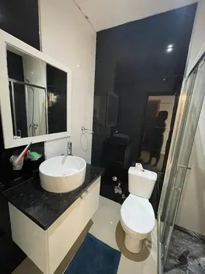a bathroom with a white toilet and a sink at Casa Mendes- Quarto individual in Praia