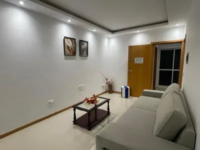 a living room with a couch and a table at Casa Mendes- Quarto individual in Praia