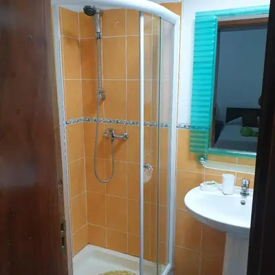 a bathroom with a shower and a sink at Gamboa-1 Praia in Praia