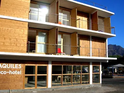 a building with a hotel in front of it at Aquiles Eco Hotel in São Pedro