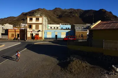 a child walking down a street in a small town at Aquiles Eco Hotel in São Pedro
