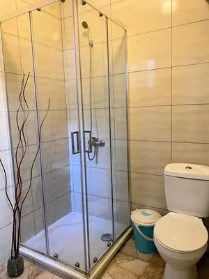 a bathroom with a shower and a toilet at Huizenmarkt Caboverde in Mindelo