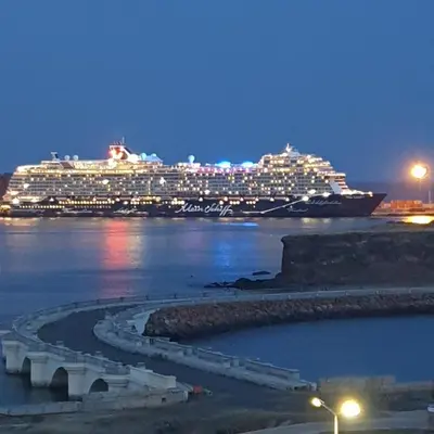 a cruise ship in the water at night at Gamboa-2 Praia in Praia