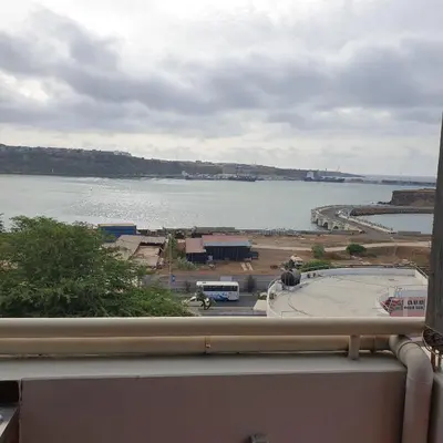 a view of a large body of water from a balcony at Gamboa-2 Praia in Praia