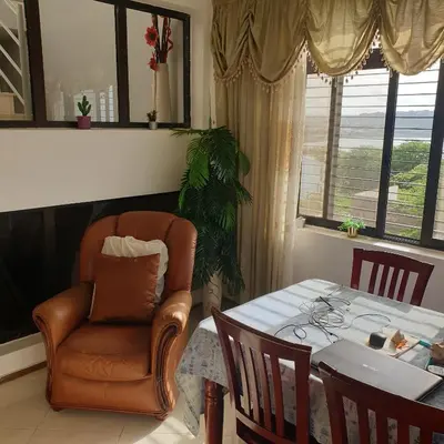 a living room with a table and a chair and a table and a chair at Gamboa-2 Praia in Praia