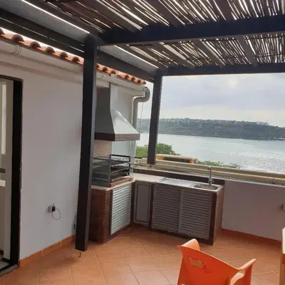 a kitchen with a large view of the water at Gamboa-2 Praia in Praia