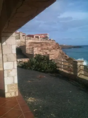 a building on top of a cliff next to the ocean at Villa 4 Stella Maris - Ilha do Maio in Vila do Maio
