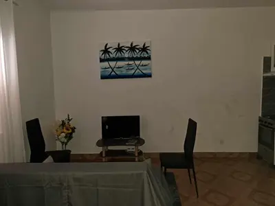 a dining room with a table and a television at Casa Nostra in Sal Rei
