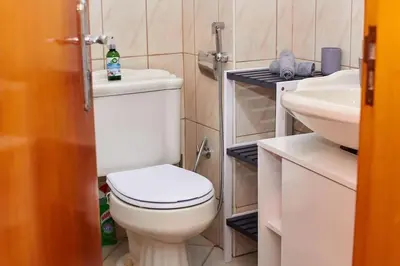 a bathroom with a white toilet and a sink at Casa Irma in Santa Maria
