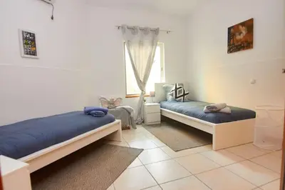 a bedroom with two beds and a window at Casa Irma in Santa Maria