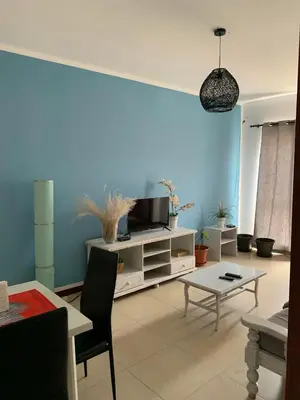 a living room with a tv and a table at Vannimar t2 in Porto Novo