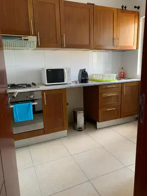 a kitchen with a stove and a microwave on a counter at Vannimar t2 in Porto Novo