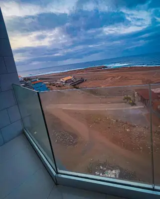 a view of the beach from a window of a building at Casa Cantinho d`ouro in Ponta do Sol