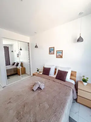 a bedroom with a large bed with two towels on it at Boa Mindelo City in Mindelo