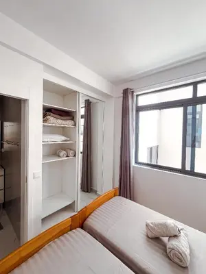 a bedroom with a bed and a window at Boa Mindelo City in Mindelo