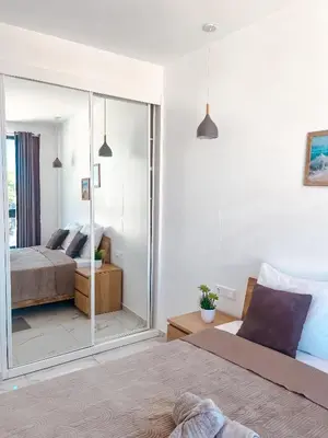 a bedroom with two beds and a large mirror at Boa Mindelo City in Mindelo