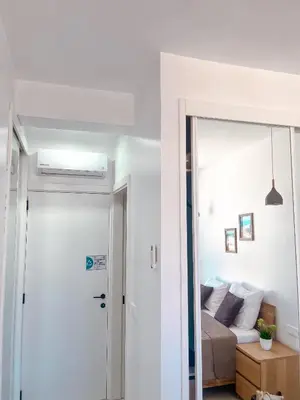 a room with a bed and a door leading to a bedroom at Boa Mindelo City in Mindelo