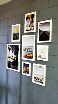 a group of pictures on a wall at Fajã Beach House in Fajã