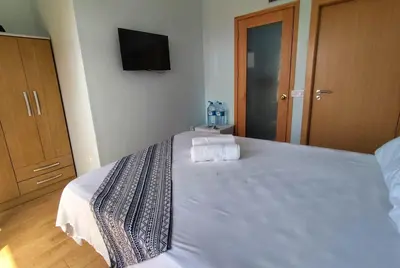 a bedroom with a bed with two towels on it at Fajã Beach House in Fajã
