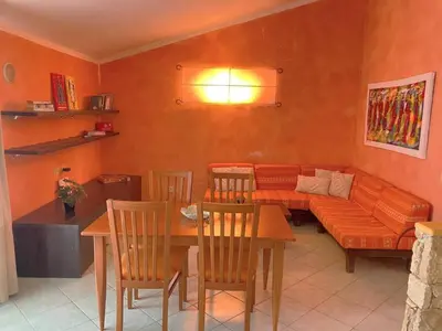 a living room with a couch and a table and chairs at Time Out DjadSal Residence AC Wifi in Santa Maria