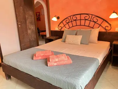 a bedroom with a bed with two towels on it at Time Out DjadSal Residence AC Wifi in Santa Maria