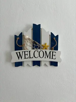 a welcome sign on a wall with a welcome sign at City Center Near Beach B&B in Tarrafal