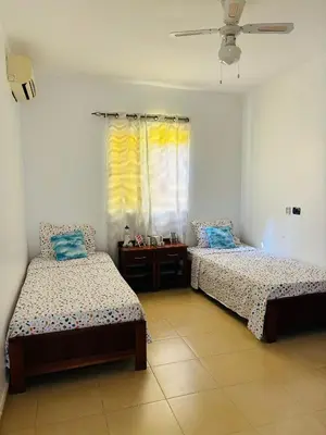 a bedroom with two beds and a window at City Center Near Beach B&B in Tarrafal