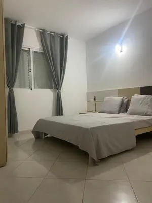a bedroom with a large bed with gray curtains at Coral beach house in Santa Maria