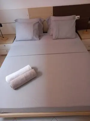 a white bed with a rolled up towel on it at Coral beach house in Santa Maria