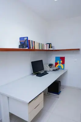 a white desk with a laptop and a phone at Nice And Modern with king size bed in Praia